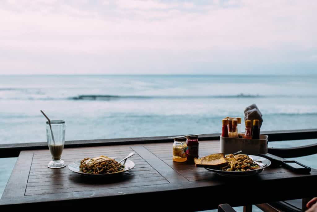food on table overlooking ocean